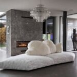 PACK sofa by FRANCESCO BINFAR√â. An icepack as a base. A bear lying on its side as a backrest. The seat is padded with gellyfoam and feather, covered with a special fabric with a texture similar to ice layers. The backrest is soft, made of polyester and covered with ecological fur. Leaning over, the big bear that supports, embraces and welcomes, for a relaxing finally freed from any constraint. The shape of the base, composed of two parts,  is irregular, and corresponds to a right angle of three meters and seventy centimeters for two fifty. Available in black or white.