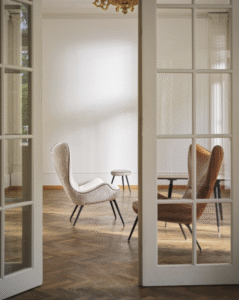 CONTESSA 1956 High-Back Chair. The original was the first modern piece of furniture produced by Wittmann after the war: a ‚Äúsporty piece‚Äù raked sharply backwards and firmly upholstered like a sports car seat. All of the experience built up by the manufacturer over the past 60 years ‚Äì as well as state-of-the art technology and materials ‚Äì went into developing this modern-day reedition.