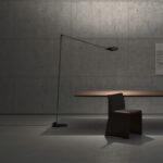 Floor lamp ELLE by TOMMASO CIMINI. A minimal yet notable floor lamp series, ELLE can be used both for direct and for diffused lighting. Jointed arm, adjustable reflector and special grid for glare control are ELLE‚Äôs defining features. Available with one or two jointed arms. Identical in shape and size to the historic halogen version, ELLE LED is renewed with a superior luminous flux and a consumption lower than 50W. The adoption LED technology ensures a very high color quality. ELLE LED, available with double or single arm, has a double dimmable light emission: direct 25W with anti-glare grid and 20W indirect. Aluminum and steel body, foot dimmer on the cable.