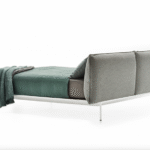 YALE BED by JEAN-MARIE MASSAUD. Structure in extruded aluminium, die-cast legs in aluminium. The structure is painted matt in the colours white, bronze and black nickel.  The upholstery in fabric or leather covers every part of the headboard and is completely removable. These contrasting seams characterise and identify the YALE Bed collection, only for the high headboard variant. Available in the colours white, medium grey and anthracite, which can be selected and  combined by the client.