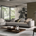 HORIZONTE modular seating system by MARCIO KOGAN / STUDIO MK27, designed 2022.The base on which the upholstered volumes rest is made from a clever combination of materials: entirely in leather or fabric or in an original mix of both to create an even more refined and prestigious look. In the fabric version, the two strips are coupled with a zip, hidden by a creased seam, presented as an aesthetic motif that allows for the practical and quick removal of the covering. On the other hand, in the base entirely covered in leather, the covering is lapped: refined and inspired by the world of haute couture, this production technique means that the strips of leather are sewn together by folding back the edges.