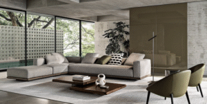 HORIZONTE modular seating system by MARCIO KOGAN / STUDIO MK27, designed 2022.The base on which the upholstered volumes rest is made from a clever combination of materials: entirely in leather or fabric or in an original mix of both to create an even more refined and prestigious look. In the fabric version, the two strips are coupled with a zip, hidden by a creased seam, presented as an aesthetic motif that allows for the practical and quick removal of the covering. On the other hand, in the base entirely covered in leather, the covering is lapped: refined and inspired by the world of haute couture, this production technique means that the strips of leather are sewn together by folding back the edges.