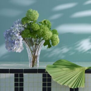 GINKGO VASE S. The vase‚Äôs immaculate silhouette fans out into a resplendent translucent arc. It is cut in a continuous, uninterrupted span of Baccarat clear crystal: a striking piece, amplified all the more by its considerable size. The GINKGO vase is capable of rendering any floral arrangement into a true botanical showcase, allowing the stems to spread amply and the buds to flourish freely. It is also an immaculate piece unto itself thanks to its a skillful showcase of craftsmanship.