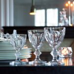 The HARCOURT 1841 collection, the oldest in the Baccarat archive, is reputed for its iconic design. Created in 1841, HARCOURT stemware has been chosen by historical icons. The HARCOURT 1841 collection has also been a staple of French power, selected since the age of Napoleon III to its contemporary use in the Palais de l‚Äô√âlys√©e. The HARCOURT 1841 glass is characterized by its architectural form: a stunning shape from the flat cut pattern of the bowl to the beveled geometry of the stem down to the hexagonal foot. Its craftsmanship is apparent from every angle of its regal and graceful form. Sipping from a HARCOURT 1841 glass is taking part in the brand‚Äôs storied and elegant past.