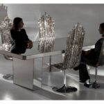 MILANO chair designed by JACOPO FOGGINI. The high-backed MILANO  chair, with its slender shape, ribbed texture and colours tending to warm grey, takes inspiration from the facade of the Milan Duomo.