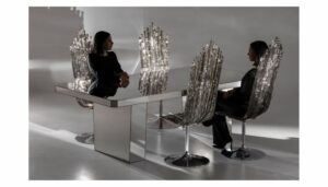 MILANO chair designed by JACOPO FOGGINI. The high-backed MILANO  chair, with its slender shape, ribbed texture and colours tending to warm grey, takes inspiration from the facade of the Milan Duomo.