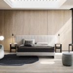 KILLIAN bed designed by E-EGGS. KILLIAN is a bed with a firm and welcoming presence. The strong and bold lines are soft and elegant at the same time, which is particularly evident in the monolithic design of the legs. Available with a narrow or wider headboard that welcomes the bedside table. The bed is available in the suspended bed-ring version or in the container bed-ring version.