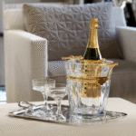 HARCOURT champagne cooler. A symbol of elegance, champagne adorns itself in the most beautiful setting possible. The Harcourt champagne bucket enhances the clear crystal's purity with silver or gold-plated handles, making it a luxurious table element. NARCISSE champagne coupes perfectly complete the scene. NARCISSE COUPE by BORIS TABACOFF IMAGINED the NARCISSE set back in 1971. In gift-set of two champagne coupes, the NARCISSE glasses add a sublime touch to the most original dinner table with its timeless design.