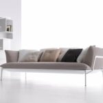 YALE SOFA by JEAN-MARIE MASSAUD, designed in 2009‚Äì2011. A minimal structure of extruded aluminium embodies reduction and lightness. Cradling cloud-like pillows, it supports a solid seating system with firm cushions. MASSAUD‚Äôs vocabulary for this line also translates into low coffee tables, both square and rectangular. The designer‚Äôs YALE COLLECTION of sofas, armchairs, and tables synthesizes form, function, and beauty, personalized pieces with varied colours, densities, and materials. MASSAUD has done more than simply design a product. He has imagined a way to enhance how people live. YALE SOFA by JEAN-MARIE MASSAUD was awarded the Compasso D'Oror Award in 2011.