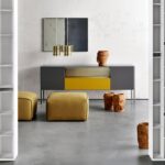 HERON by RODOLFO DORDONI, designed in 2016. System of storage units with doors, drawers and open compartments for the different domestic, office and public environment. Collection composed of different storage units in terms of dimensional combinations and frontal equipment.