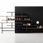 SUPER_POSITION by Jean Nouvel Design, designed in 2018‚Äì2019. Formal lightweight, graphic sign, simple design, harmonious aesthetics, essentiality are the hallmarks of SUPER_POSITION bookcase family, designed by JEAN NOUVEL DESIGN. ‚ÄúOverlapped lines are a tribute to the lightness of horizontality. Uninterrupted vertical lines cross the shelves, which extend like small diving boards into the void. Objects, vases and sculptures can express their differences of scale in empty spaces, in the niches in the middle or on the ends of the overlapped lines.‚Äù JEAN NOUVEL SUPER_POSITION is available in a monochromatic version, two-tone or two-material version.