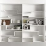 MELODY by NEULAND INDUSTRIEDESIGN, designed in 2008. An individual flexible and customised furnishing solution, not just a simple bookcase. This is MELODY‚Äôs visiting card, offering a comfortable and eye-catching horizontal storage, also for big objects. The layout of the shelves with its gritty graphic pattern, sends an idea of movement, a sort of discreet waving. Functionality and modularity have always been key features for the designer duo NEULAND INDUSTRIEDESIGN, together with a catchy and innovative design. In this case the module is single, but always vertically revertible, which allows to give horizontal continuity or discontinuity to the shelves, by combining more modules. Offered either in a monochromatic version or with contrast backrest, Melody can be modified in time and space, for unique environments.