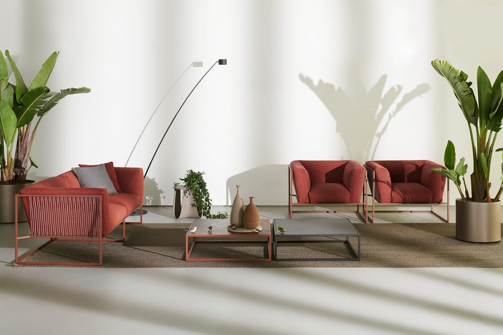 ARPA indoor and outdoor sofa, armchair and side table by RAM√ìN ESTEVE, designed in 2020. As its name implies, ARPA collection is inspired by the harp, one of the most beautiful and mesmerizing musical instruments. Unlike the meticulous work involved in manufacturing a harp, in designing this collection, rigorous paring down was applied, resolving each piece with the least possible number of elements. ARPA collection combines the stability of the orthogonal external shape with the softness and comfort of the inner cushion shell. The thin strings add elegance and fineness to every piece, giving a special sense of lightness, as if the whole cushion mass was hanging from the structure. Designed to be timeless, ARPA aims to become an icon, not only for aesthetical reasons, but also for its functionality and comfort.