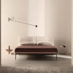 YALE BED by JEAN-MARIE MASSAUD, designed in 2018. MASSUAUD‚Äôs latest creations were conceived for a functional and contemporary home, expressing a style and a way of living in which formal simplicity does not exclude creativity, quality, innovation and a sophisticated aesthetics. The designer extends YALE X‚Äôs project idea to the night area, proposing again YALE‚Äôs softness and comfort for the headboard, as well as the refined aesthetics of the sofa‚Äôs stand as the hallmark of the bedframe. The bed concept means a welcoming headboard, capable to offer the best comfort to relax, read or watch TV, a good mattress and a comfortable pillow.