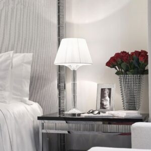 MILLE NUITS lamp created by MATHIAS. The MILLE NUITS lamp combines refinement and timelessness. Covered of beveled-cut crystal and topped with a textile lampshade, it adds a baroque and modern touch at the same time to every interior. The MILLE NUITS story with chandeliers and candelabras continues to unfold with a new creation from the designer MATHIAS. The MILLE NUITS lamp combines refinement and timelessness. Covered of beveled-cut crystal and topped with a textile lampshade, it adds a baroque and modern touch at the same time to every interior. The crystal is magnified by the beveled-cut which creates a play of light in the transparency of the material.