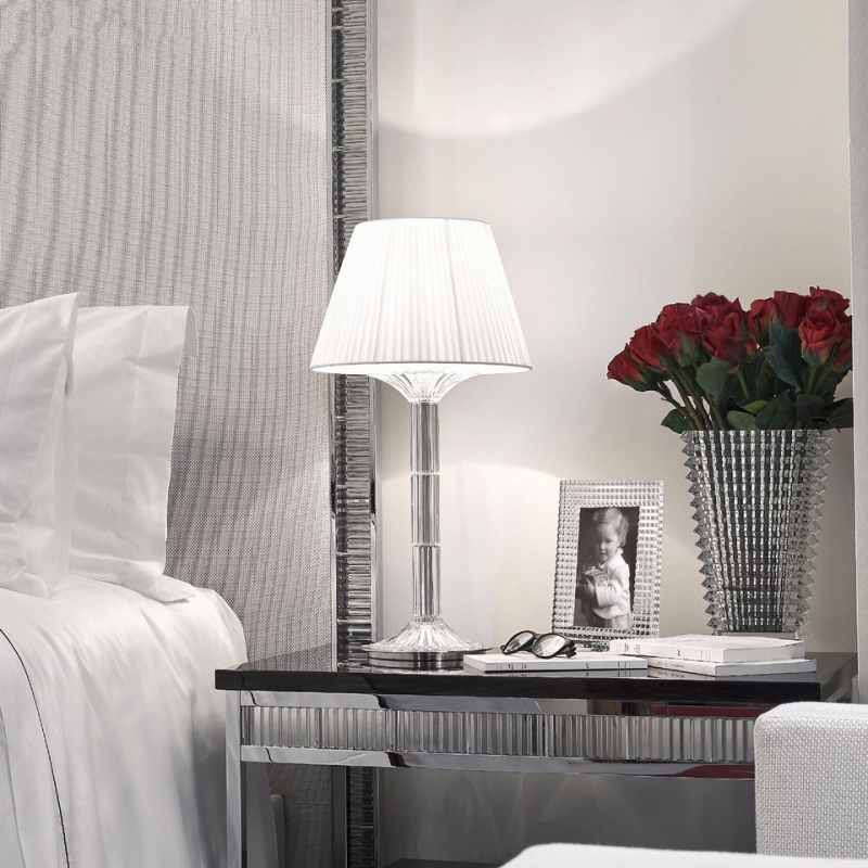 MILLE NUITS lamp created by MATHIAS. The MILLE NUITS lamp combines refinement and timelessness. Covered of beveled-cut crystal and topped with a textile lampshade, it adds a baroque and modern touch at the same time to every interior. The MILLE NUITS story with chandeliers and candelabras continues to unfold with a new creation from the designer MATHIAS. The MILLE NUITS lamp combines refinement and timelessness. Covered of beveled-cut crystal and topped with a textile lampshade, it adds a baroque and modern touch at the same time to every interior. The crystal is magnified by the beveled-cut which creates a play of light in the transparency of the material.