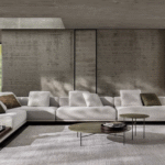 HORIZONTE modular seating system by MARCIO KOGAN / STUDIO MK 27. Perfectly consistent with MARCIO KOGAN's design philosophy, the HORIZONTE modular seating system is the result of a clear architectural vision: a rigorous shape, raised seven centimetres off the ground thanks to a recessed plinth in matt black varnished metal, which gives the sofa a special feeling of suspension. A platform on which the upholstered elements are located  - seats, backrests and armrests - all conceived as large cushions with bold proportions and a strong personality.