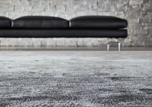 RUG DIBBETS RAINBOW - DESIGNER RODOLFO DORDONI 2018. WITH A MACRO PATTERN REMINISCENT OF THE WAVE SIGN OF ROBERTO BURLE MARX‚ÄôS FAMOUS WALK ON THE BEACH OF IPANEMA, THE DIBBETS CARPET RECALLS THE SOFT LINES TYPICAL OF THE SIXTIES. AN AESTHETIC REFERENCE THAT IS ACCENTUATED BY THE SLIGHT ROUNDNESS OF THE FOUR CORNERS.¬†  CRAFTED WITH SHINY AND OPAQUE YARNS, IN TWO NEUTRAL SHADES, IT IS REVIVED BY A GAME OF SHADOWS CREATED BY THE DIFFERENT INCIDENCE OF LIGHT ON THE SURFACE.  IT IS AVAILABLE IN THREE