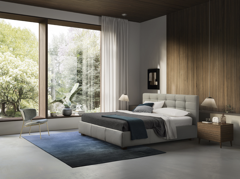 MONTEREY bed designed by DANIELE  LO SCALZO MOSCHERI. MONTEREY reworks the archetypal tradition of elegant diamond-tufted padding but puts a new spin on the pattern with sleek horizontal sections. Original quilting techniques have been adopted to celebrate the legendary expertise of Italian upholstery artisans. The item is available with three versions of the feet in wood or one version of the feet in metal with the option of choosing a look and height from the ground that suits the customer best. The MONTEREY bed is available with a fixed bed base or container unit. Can be upholstered in fabric or leather.