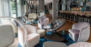 REDONDO ARMCHAIR, BOHEMIANARMCHAIR, FJORD STOOL AND BLOOMY LOW TABLE BY PATRICIA URQUIOLA - MOTEL ONE STUTTGART, GERMANY, 2019  INTERIORS: MOTEL ONE ARCHITECTURE: MOTEL ONE PHOTO CREDIT: MOTEL ONE