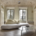 PACK sofa by FRANCESCO BINFAR√â. An icepack as a base. A bear lying on its side as a backrest. The seat is padded with gellyfoam and feather, covered with a special fabric with a texture similar to ice layers. The backrest is soft, made of polyester and covered with ecological fur. Leaning over, the big bear that supports, embraces and welcomes, for a relaxing finally freed from any constraint. The shape of the base, composed of two parts,  is irregular, and corresponds to a right angle of three meters and seventy centimeters for two fifty. Available in black or white.