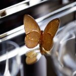 PAPILLON lucky butterfly DIAMOND. A small and precious lucky-charm object, the Baccarat butterfly gilded with fine gold features a diamond cut giving brilliant reflections of light.