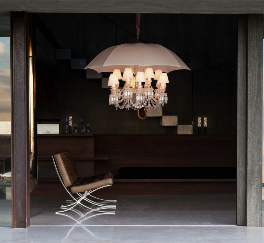 MARIE COQUINE chandelier by PHILIPPE STARCK, who has assembled a very peculiar inventory, as singular in scale as in concept. The components include the Clear crystal 12-light Z√©nith chandelier, 12 incandescent bulbs, 12 white Zenith lampshades, Baccarat‚Äôs signature red octagonal crystal, and an ivory canvas umbrella with a chestnut wood handle, signed by Baccarat and Starck upon the metallic band. Boasting an unforgettable visual impact, the surrealist and poetic chandelier showcases the iconoclastic PHILIPPE STARCK‚ÄôS uninhibited humor and originality. More than a light source, MARIE COQUINE is a veritable sculpture and contemporary art piece. A limited edition MARIE COQUINE FLOOR lamp is also a true collector‚Äôs item.