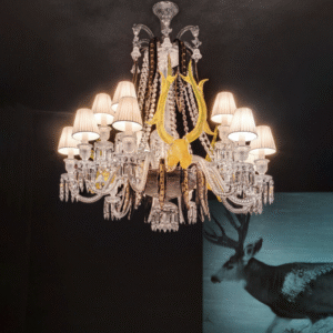 Crystal chandeliers √âTRANGE Z√âNITH DEERS. Imagined by PHILIPPE STARCK in collaboration with glassware artist ARISTIDE NAJEAN, the ¬´ Z√âNITH SUR LA LAGUNE ¬ª adorned with the heads of deer is a magic combination where Baccarat crystal meets Murano glass. 15-light chandelier based on a 24-light Z√©nith chandelier in clear crystal consisting of 15 twisted Z√©nith arms, 3 acid yellow deers and 18 black and gold leaves in Murano glass. 15 white Z√©nith lampshades included.