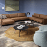 NIKI sofa designed by E-GGS. The design of the NIKI sofa is the result of a superimposition of planes. A light and linear top, together with the backrest and armrests, contains soft and ample cushions that give the sofa a comfortable but rigorous look. The detail of the wooden feet that makes it a unique body with the armrest, characterizes it and softens the lines. Also available a comfortable corner coffee table for the most elaborate compositions.