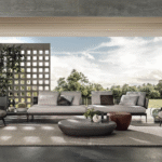 BELT CORD OUTDOOR by RODOLFO DORDONI, designed in 2022.The enveloping and comfortable body of the BELT seats designed for indoor use in 2021 also shapes the outdoor version. The band which, in the original design, outlines the silhouette of the volume recalling the shape of a belt, in its outdoor version becomes a corded contour in the colours Sand and Dark Brown, covering the shiny Bronze metal frame.