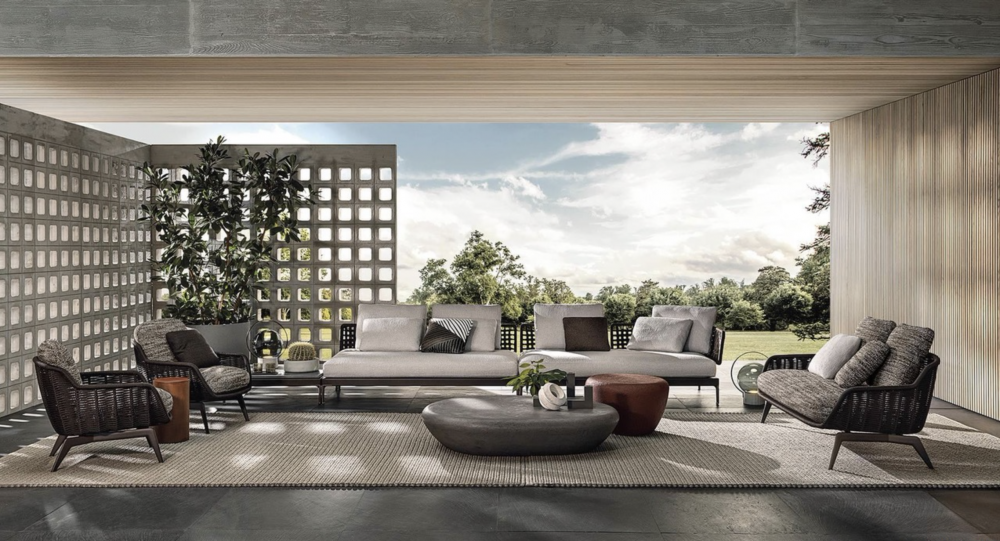 BELT CORD OUTDOOR by RODOLFO DORDONI, designed in 2022.The enveloping and comfortable body of the BELT seats designed for indoor use in 2021 also shapes the outdoor version. The band which, in the original design, outlines the silhouette of the volume recalling the shape of a belt, in its outdoor version becomes a corded contour in the colours Sand and Dark Brown, covering the shiny Bronze metal frame.