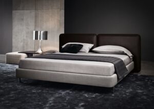 BED TATLIN IS ALL ABOUT THE HEADBOARD; UPHOLSTRED IN SADDLE -HIDE , IN THE COLOURS MUD; TOBACCO AND BLACK, WITH DETAILED WORKMANSHIP THAT CALLS TO MIND REFINED LUGGAGE - IN THE ROUNDED CORNELS ,THE STITCHING ,THE LUSH THICKNESS - DESIGNER RODOLFO DORDONI