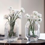 OCTOGONE vase designed by THOMAS BASTIDE. The signature of all Baccarat chandeliers, the octagonal tassel is here transformed into a vase. The clear-cut lines, corners and roundness are combined to reflect the light.