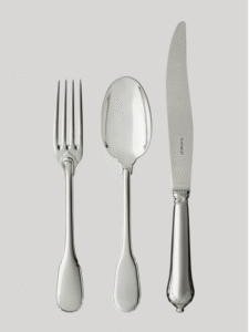 NOAILLES cutlery collection. Since the 16th century, Augsburg, Bavaria has been renowned for the unparalleled savoir-faire of its silversmiths. For Louis-Victor Puiforcat, a keen collector of high-quality pieces, an early design from this Bavarian city inspired the production of this sterling silver cutlery. The apparent simplicity of the design is contrasted by the refinement of every detail: the curved contour, the handle outlined with a fine thread, the elegant flame- shaped button at the base of the fork and spoon