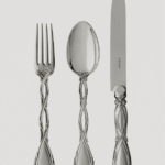 ROYAL cutlery collection. Louis-Victor Puiforcat, who transformed the simple family cutlery shop into a renowned silversmithing workshop at the end of the 19th century, drew his inspiration from the masterpieces of past craftsmen, which he revived. Thus, the design of the ROYAL line of cutlery had been conceived by  18th century silversmith, Nicolas Cornu. Its nobility lies in the refinement of its curved sterling silver handle, enhanced by an elegant interlacing of rocaille branches. The set‚Äôs sophistication demands the perfect mastery of traditional craftsmanship, including the delicate lime finish. The collection, also available upon request in gold immersion finish, includes a wide selection of cutlery and specialty accessories (serving pieces and oyster, snail and lobster forks, etc.)
