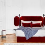 WINGS BED by JAIME HAYON, Sweet dreams come easily on wings‚Ä¶ The tiltable side wings of the WINGS BED are at the heart of an interplay between intimacy and openness. They cradle the person sleeping like a cocoon, or open up to transform the bedroom into a place where people wish to spend time ‚Äì and not just at night. Leather covered nightstands and adjustable LED reading spotlights are carried by a slender, textured powder coated frame finished in black.