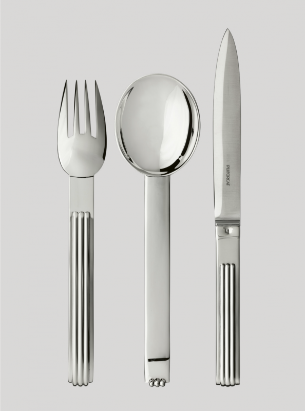 DEAUVILLE cutlery collection. At the time of expanding seaside tourism, elegant villas and the renowned construction of the celebrated sea bath cabins, DEAUVILLE  was rich in architectural influences that inspired JEAN PUIFORCAT. In 1937, he designed a cutlery collection with a solid, slightly curved handle and three rectilinear grooves that subtly capture light. A highly contemporary signature.