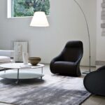 DERBY armchair by NO√â DUCHAUFOUR LAWRENCE, designed in 2010. Armchair/berg√®re, pouf. Armchair with steel base, swivel or fixed with feet and stiff polyurethane external body covered with cowhide 95. Upholstery of internal body and pouf in polyurethane/ heat-bound polyester fibre with elastic strips suspension. Removable fabric or leather cover. Pouf steel frame.