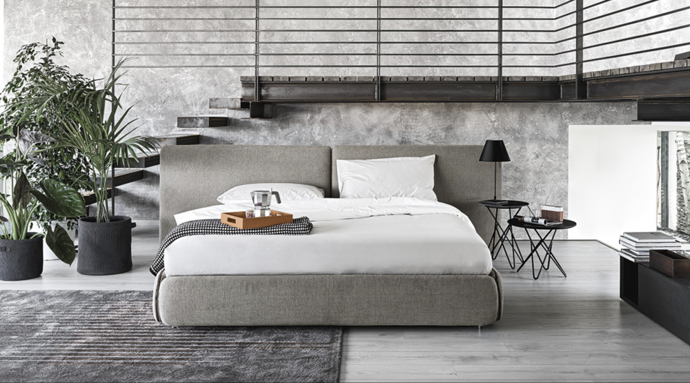 ZIP bed designed by DANIELE  LO SCALZO MOSCHERI. ZIP is a versatile, unisex and laid-back project whose sleek design hinges on a common household object - a zip. The ZIP is a decorative and functional feature for wrapping the padded panels and transforming simple accessories into a product which can be put together to suit your requirements. The upholstered bed has fully removable covers. This item is available with a plexiglass foot. The ZIP bed is available with a fixed bed frame and can be upholstered in fabric or leather with a matching beige, brown, light-grey or dark-grey zip.