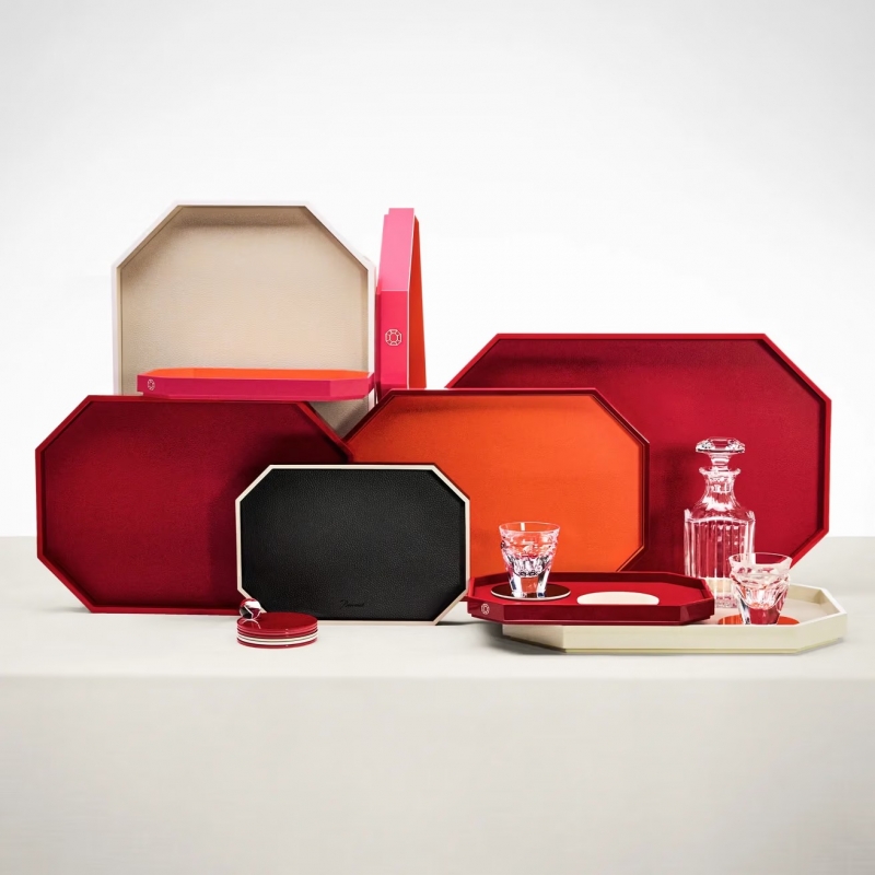 THE OCTOGONE Collection.THE OCTOGONE TRAY is a beautiful, lacquered piece, available in 3 sizes. Inspired by the red octagonal tassel, the iconic signature of Baccarat, a series of refined lacquered accessories comprise these new pieces, which come to enlarge the OCTOGONE collection. The tray, in the shape of an octagon, is meticulously handcrafted using ancestral artistry. Its brilliant surface captures the light and highlights Baccarat’s crystal creations. Each tray comes with a removable leather insert, adding an elegant contrast of materials and textures. THE OCTOGONE TRAY exists in a variety of shades, enriched over the seasons and matched with the coaster from the same collection.