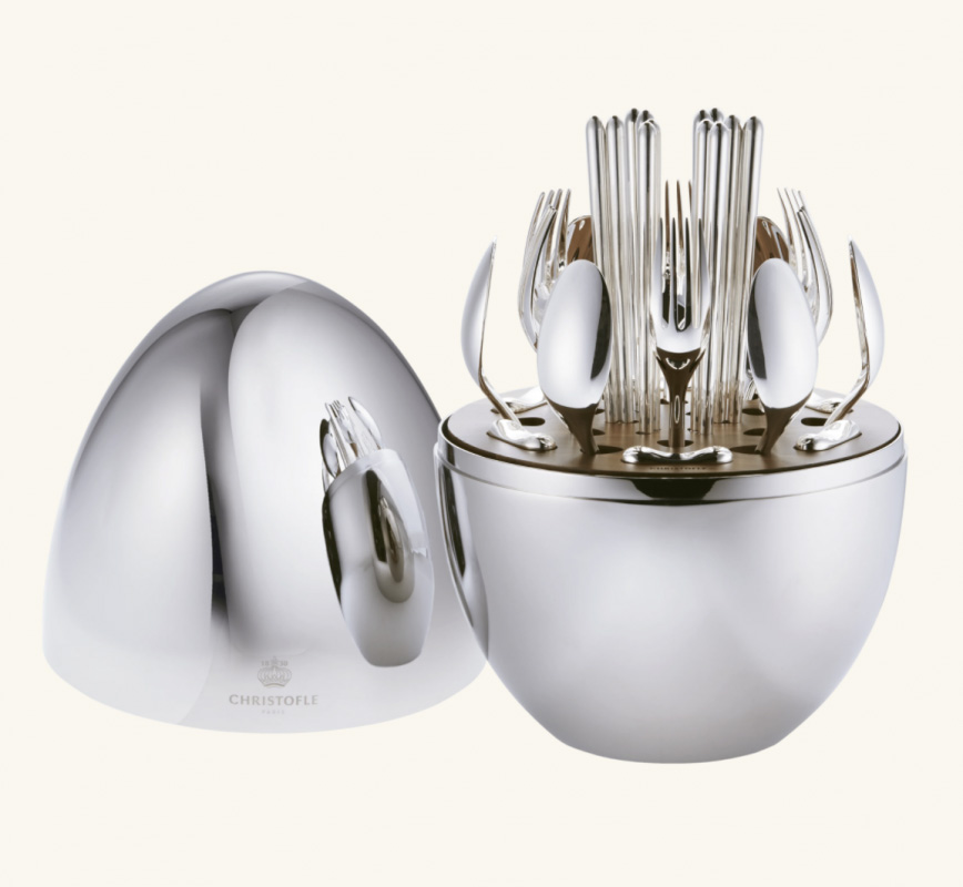 MOOD Party by Christofle. Designed for one's informal dining moments, MOOD Party by Christofle is a set featuring cutlery for 6 people for life's sweet & savory moments. The set includes the following: 6 butter knives, 6 small spoons, 6 appetizer/dessert forks, 6 silver-plated cocktail picks, 1 storage capsule. The egg-shaped storage capsule is made of a mirror-polished steel with a walnut base interior. Christofle shakes up the art of entertaining with a new concept that reflects the current zeitgeist. MOOD Party by Christofle, with its avant-garde vision of convenience and comfort, invites itself to all tables as a promise of sharing and memories.