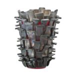 RITAGLI (‘Scraps’) uses a glassmaking technique devised by FULVIO BIANCONI, the most innovative and suggestive of the twentieth century: small rectangular glass strips applied one on top of the other, on a base of a truncated cone which has been blown and worked by hand. Iridescent green and aquamarine, iridescent sand and red meet on a contour that seems to have always been in existence, yet it is dated 1989. Like desert plants. Futuristic architecture.